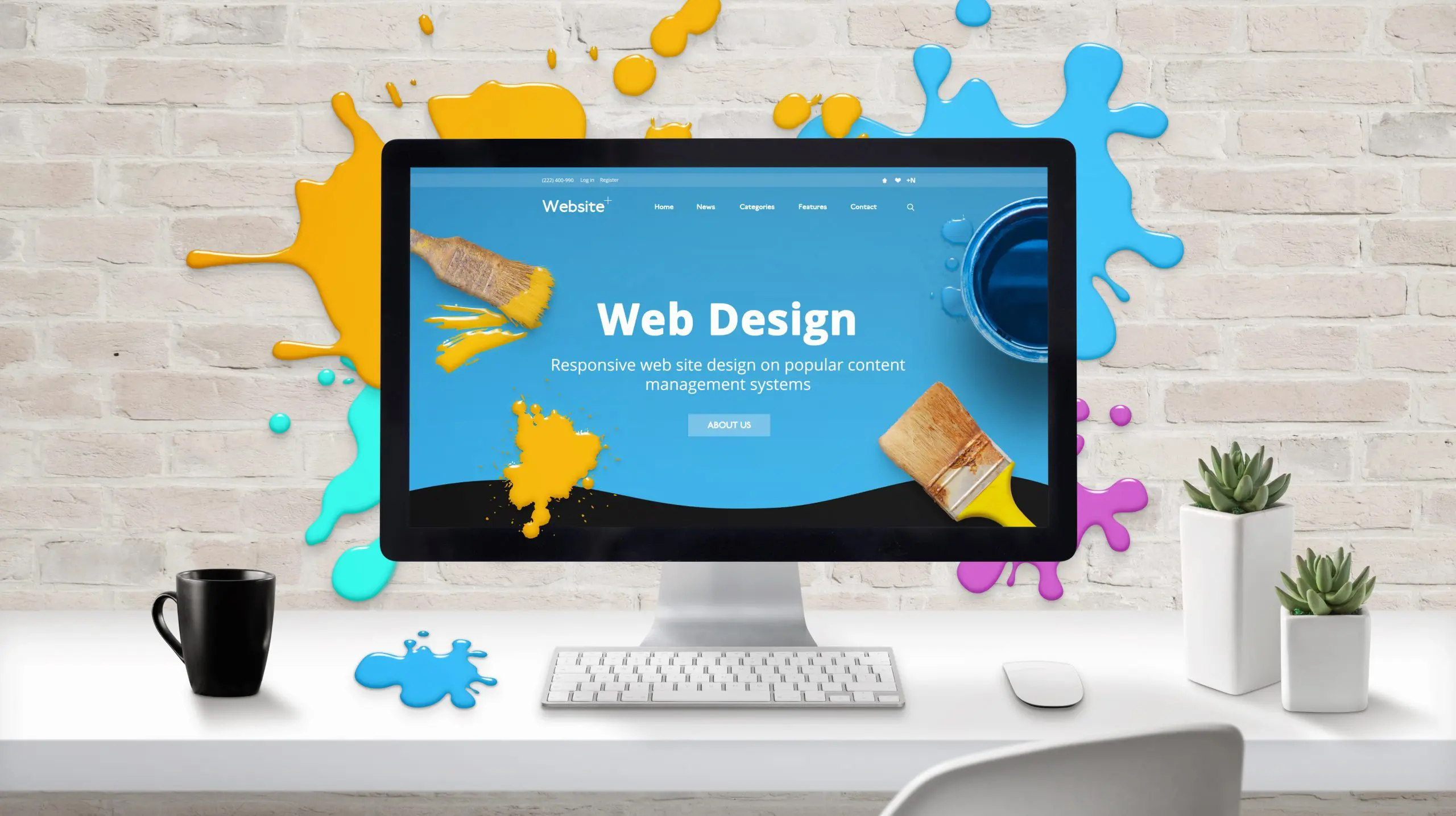 Web design concept. Modern web site on computer display surrounded by brush color drops.