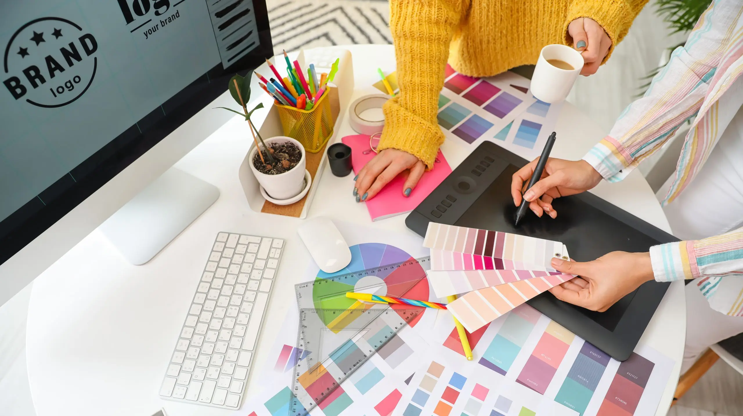 Graphic designer with colleague working in office
