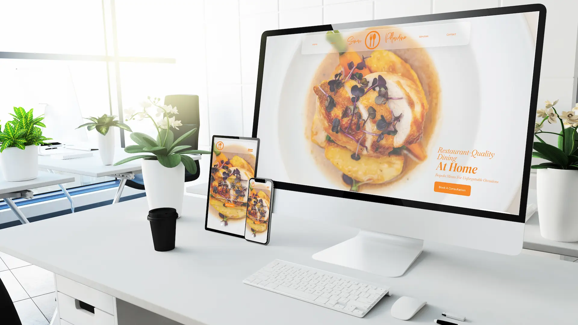 Desk showing computer screen, tablet and mobile phone with a website home page on each screen