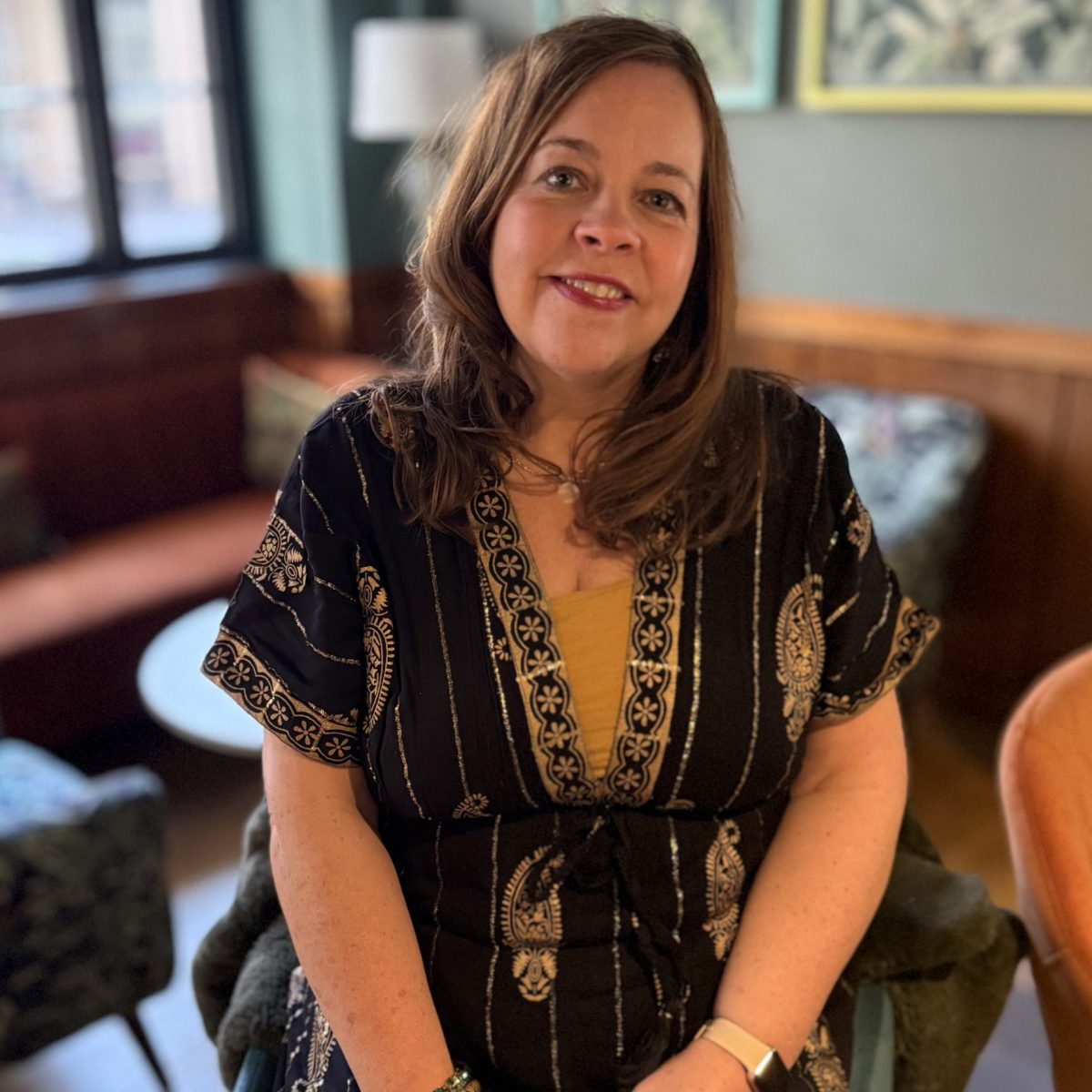 Debbie sitting on a stool